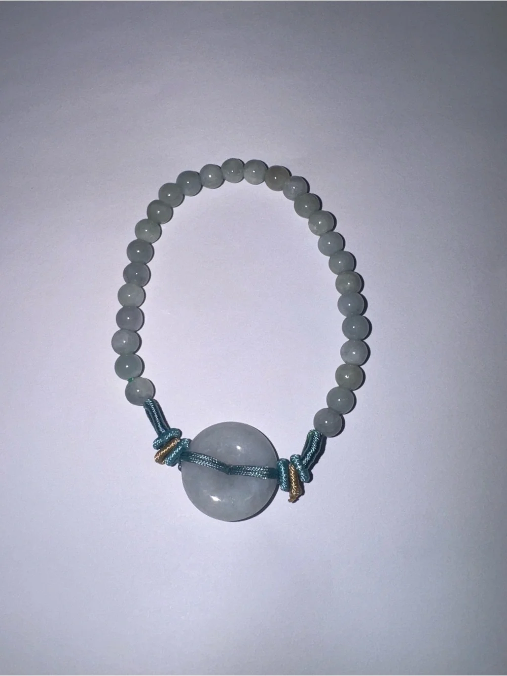Handmade Light Green Jade Bead Bracelet with donut pendant.